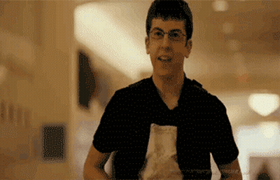 Man In Glasses And Black Shirt Holding Food Bag GIF