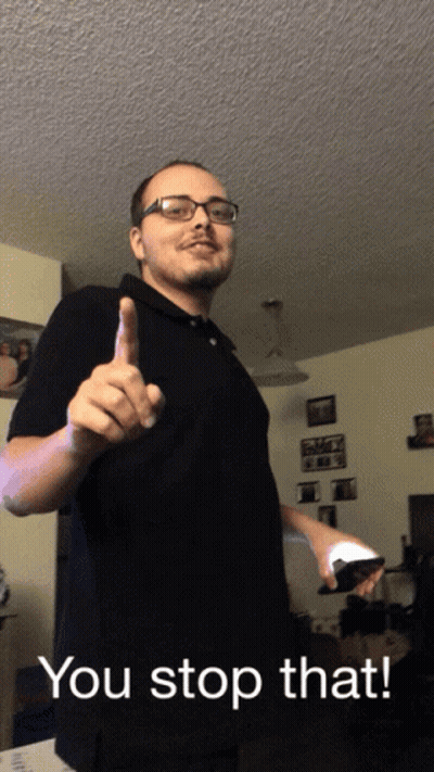 Man In Glasses And Black Shirt Holding Remote Saying You Stop That GIF
