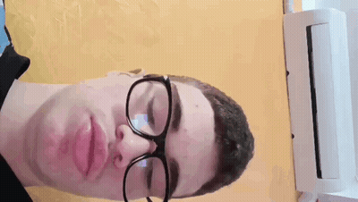 Man In Glasses And Black Shirt Laying Down GIF