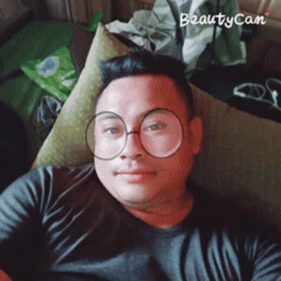 Man In Glasses And Black Shirt Laying On Couch With Beautycam Watermark GIF