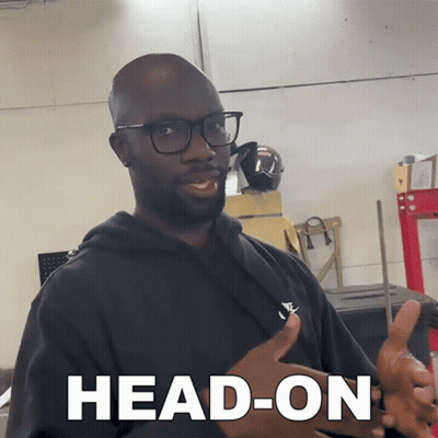 Man In Glasses And Black Shirt Saying Head-On GIF