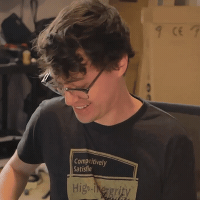 Man In Glasses And Black Shirt Saying Outrageous GIF