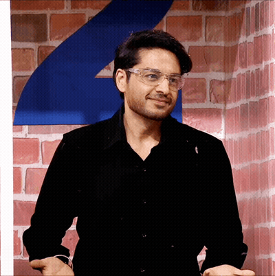 Man In Glasses And Black Shirt Smiling GIF