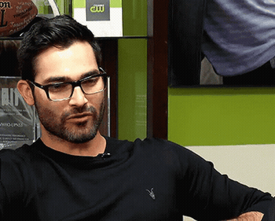 Man In Glasses And Black Shirt With CW Logo GIF
