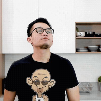 Man In Glasses And Black T-Shirt With Cartoon Man GIF