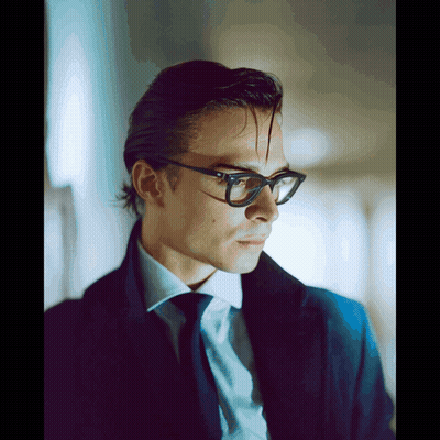 Man In Glasses And Blue Coat Looking To Side GIF