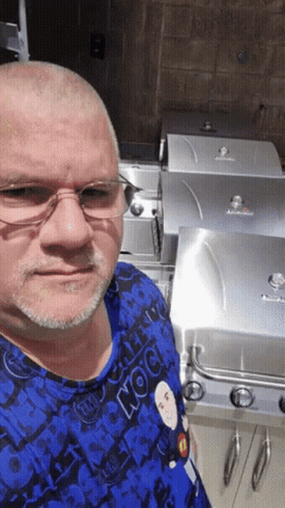 Man In Glasses And Blue Rock Shirt At Grill GIF