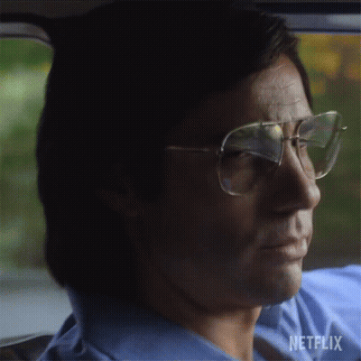 Man In Glasses And Blue Shirt Driving Car With Netflix GIF