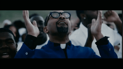 Man In Glasses And Blue Shirt Hands Up In Crowd GIF