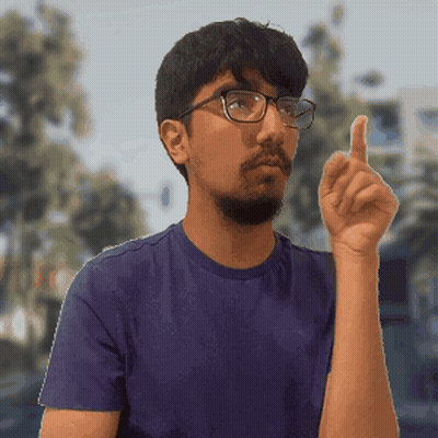 Man In Glasses And Blue Shirt Pointing Up GIF