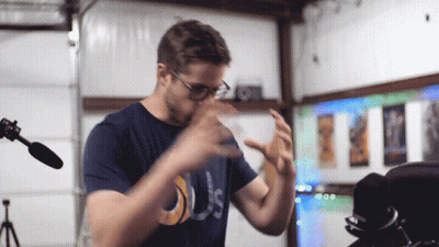 Man In Glasses And Blue Shirt Saying Us GIF