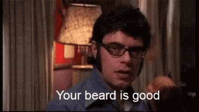 Man In Glasses And Blue Shirt Saying Your Beard Is Good GIF