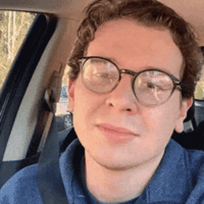 Man In Glasses And Blue Shirt Sitting In Car GIF