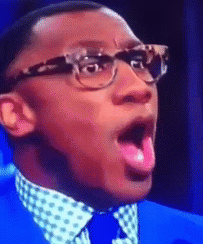 Man In Glasses And Blue Suit Sticking Tongue Out GIF