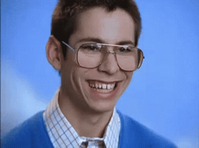 Man In Glasses And Blue Sweater Making Funny Face GIF