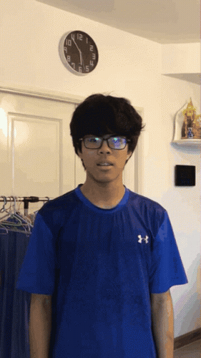 Man In Glasses And Blue Under Armour Shirt Beside Clock GIF