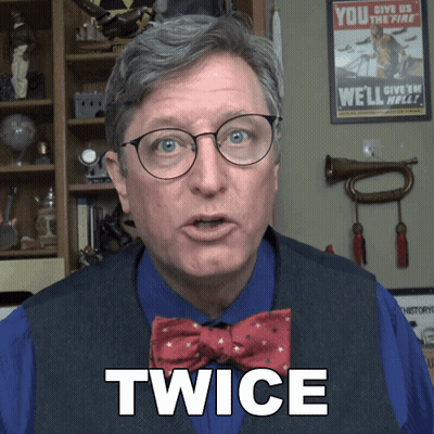 Man in Glasses and Bow Tie With Twice on Chest
