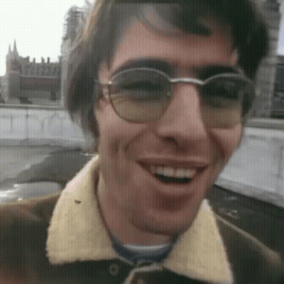 Man In Glasses And Brown Jacket Smiling GIF