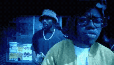 Man In Glasses And Bucket Hat In Front Of 99 Cents Sign GIF
