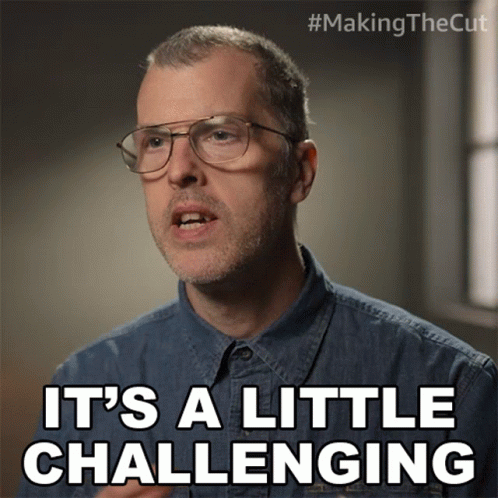 Man In Glasses And Denim Shirt Says It's A Little Challenging GIF