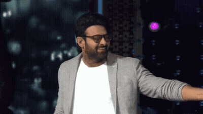 Man In Glasses And Gray Jacket In Purple Light GIF