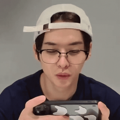 Man In Glasses And Hat Holding Cell Phone GIF