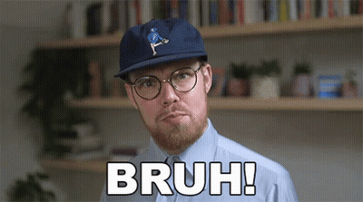 Man In Glasses And Hat Saying Bruh In Front Of Bookshelf GIF