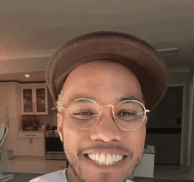 Man In Glasses And Hat Smiling In Kitchen GIF