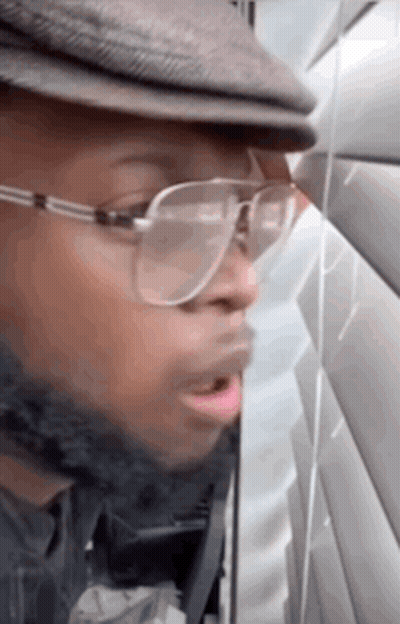 Man In Glasses And Hat Talking On Phone GIF