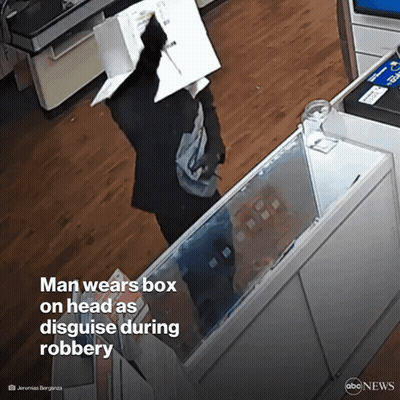 Man In Glasses And Hat With Another In Dark Room GIF