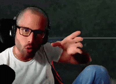 Man In Glasses And Headphones Making Funny Face On Couch GIF