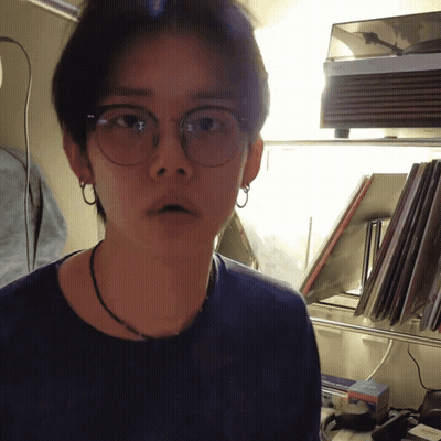 Man In Glasses And Necklace By Record Player GIF