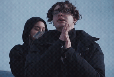 Man In Glasses And North Face Jacket Next To Woman GIF