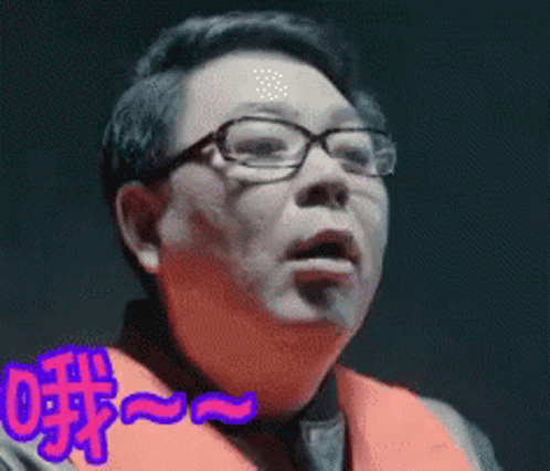 Man In Glasses And Orange Scarf Making Funny Face GIF