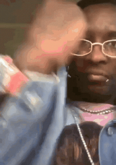 Man In Glasses And Pink Shirt Holding Bottle GIF