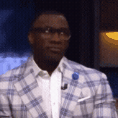 Man In Glasses And Plaid Jacket With Blue Pin GIF