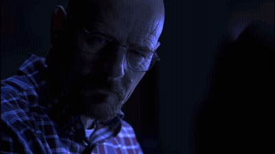 Man In Glasses And Plaid Shirt Looking In Dark GIF