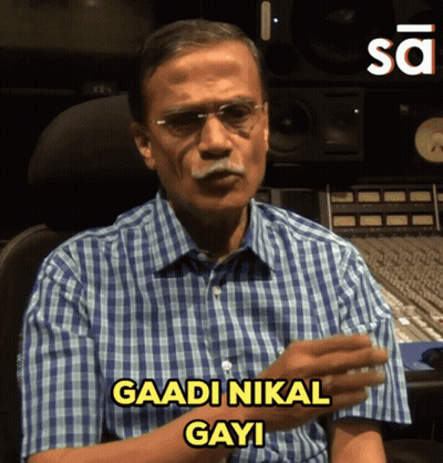 Man In Glasses And Plaid Shirt Says Gaadi Nikal Gayi GIF