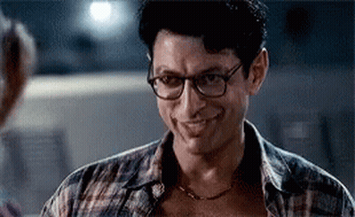 Man In Glasses And Plaid Shirt Smiling At Woman GIF