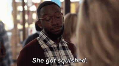 Man In Glasses And Plaid Shirt Talking To Woman Saying She Got Squished GIF