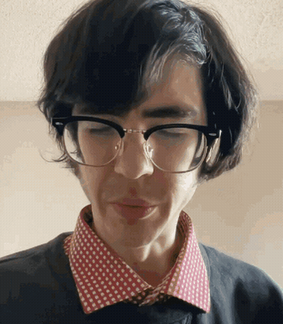 Man In Glasses And Polka Dot Shirt Looking Down GIF