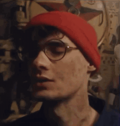 Man In Glasses And Red Beanie Saying Been Thinking About You GIF