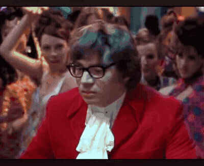 Man In Glasses And Red Jacket Before Crowd GIF