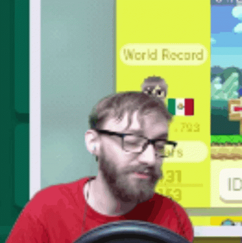 Man In Glasses And Red Shirt Playing Video Game With World Record GIF