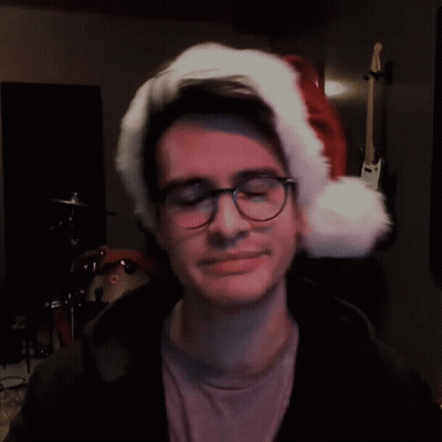 Man In Glasses And Santa Hat Looking Sideways GIF