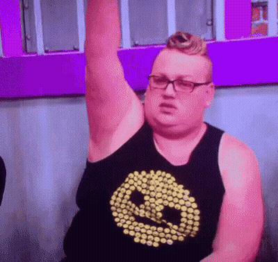 Man In Glasses And Smiley Tank Top Holding Arm Up GIF