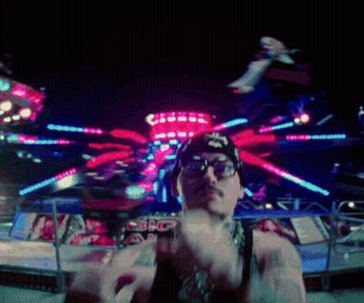 Man In Glasses And Star Hat At Carnival GIF