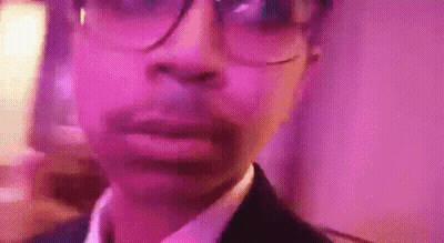 Man In Glasses And Suit At Pink Wall GIF