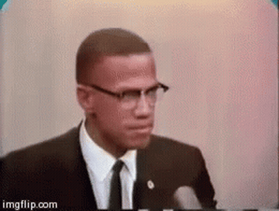 Man In Glasses And Suit Giving Speech At Microphone GIF