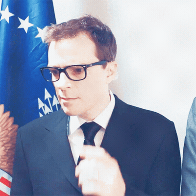 Man In Glasses And Suit In Front Of American Flag GIF